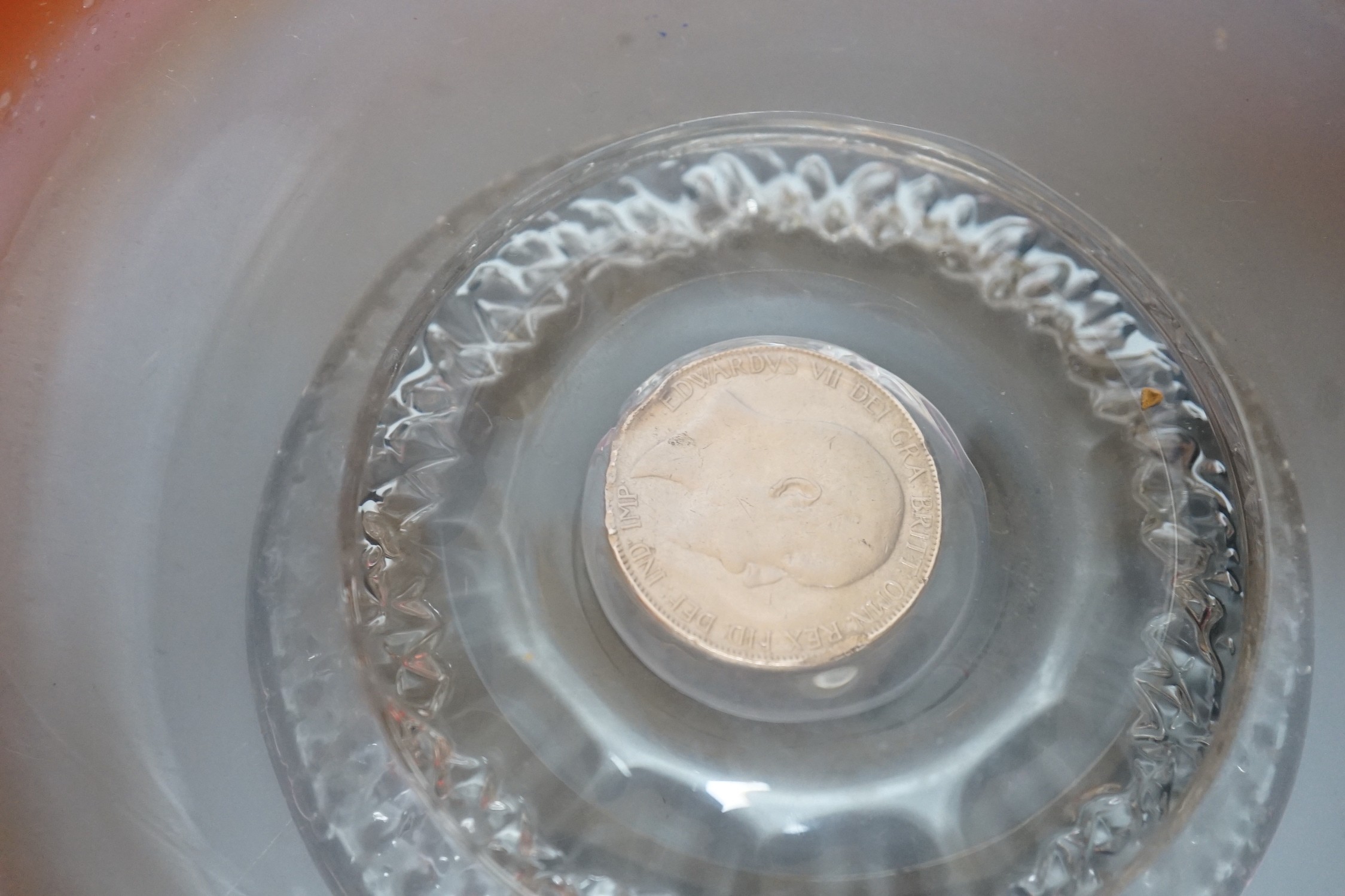 A pair of early 20th century ‘fancy’ glass dishes with inset coins to base, 29cm diameter